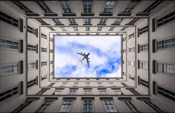 istock Jet airplane passing on cluod sky in a city 644958642