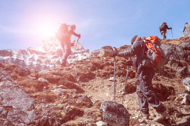 istock Silhouettes of Mountain Climbers walking up on rocky Footpath 644962880