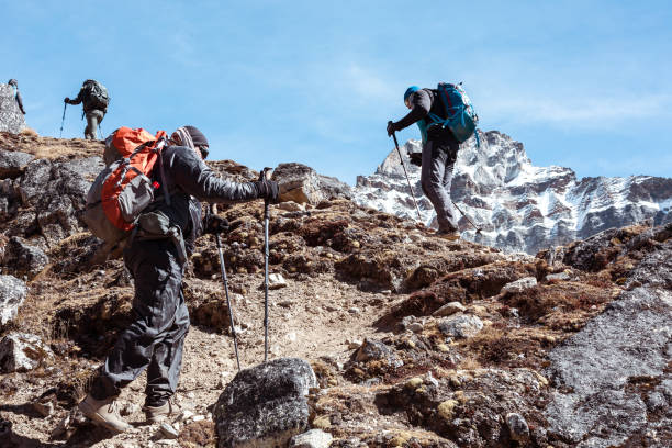 istock Mountain Climbers Team walking up on rocky Footpath 644963148