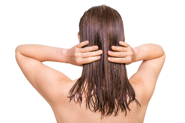istock Attractive woman applying conditioner on her hair 644966440