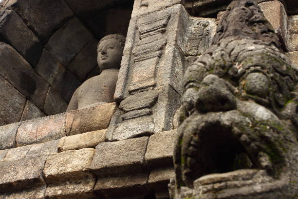 istock Buddha statue in stupa, Borobudur, near Yogyakarta, Java, Indonesia 644966536
