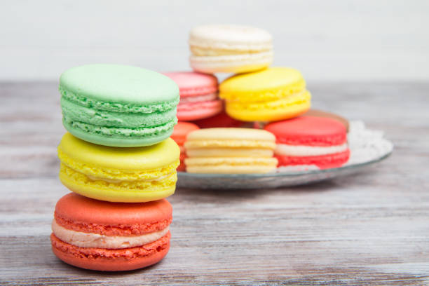 istock French macaroon soft tender colors on wooden background 644969458