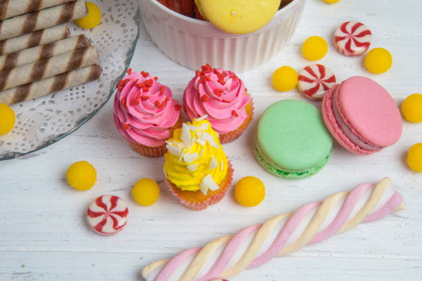 Colorful cupcakes and macaroons on table with festive Candy bar. Wedding sweets