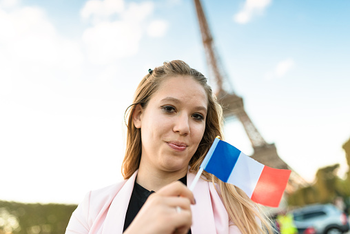 tourist in paris with a french flag