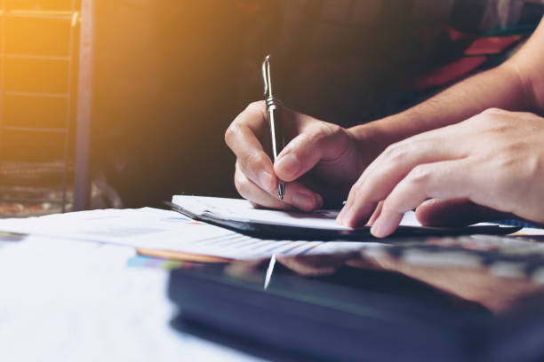 istock Woman hands writing note at home and calculate finance. 644976598