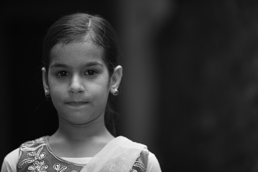 Poor rural village girl standing portrait.