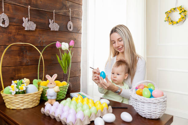 istock Happy Mother and her cute child celebrating Easter at home 644993792