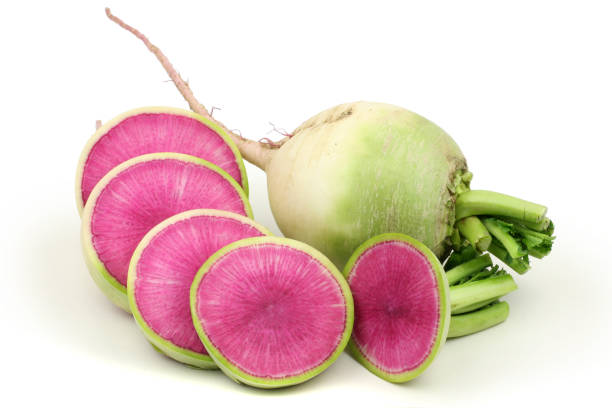 One whole and sliced watermelon radish isolated on white background One whole and sliced watermelon radish isolated on white background radish stock pictures, royalty-free photos & images