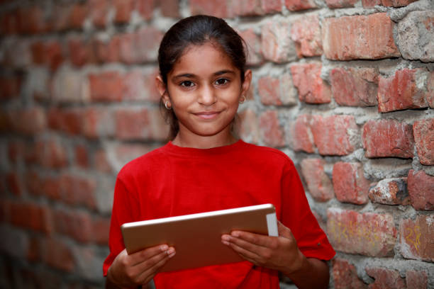 istock School girl holding digital Tablet 644996880
