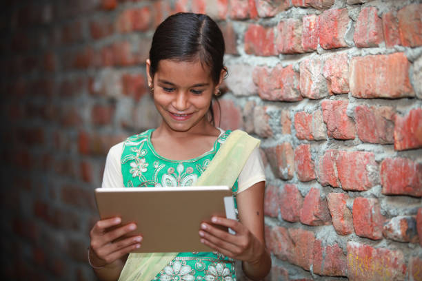 istock Cheerful village girl watching in tablet 644998012