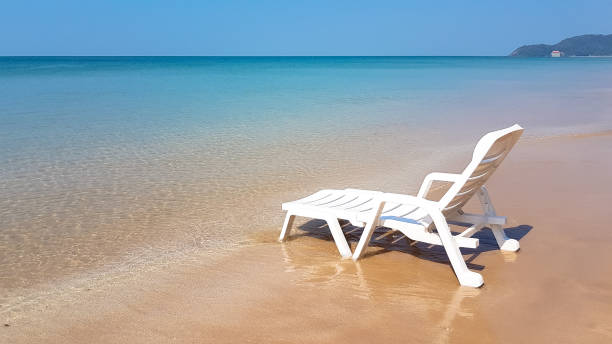 istock white armchair on the wet beach in sunny time 644998710