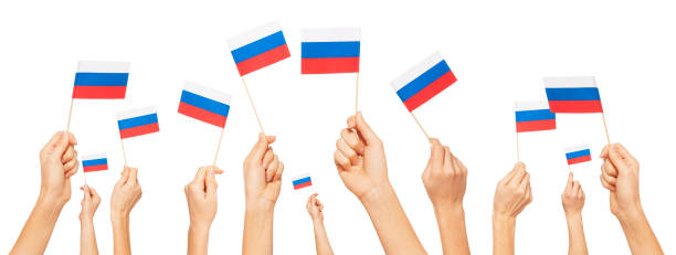 istock Hands holding and raising small flags of Russia 645002346