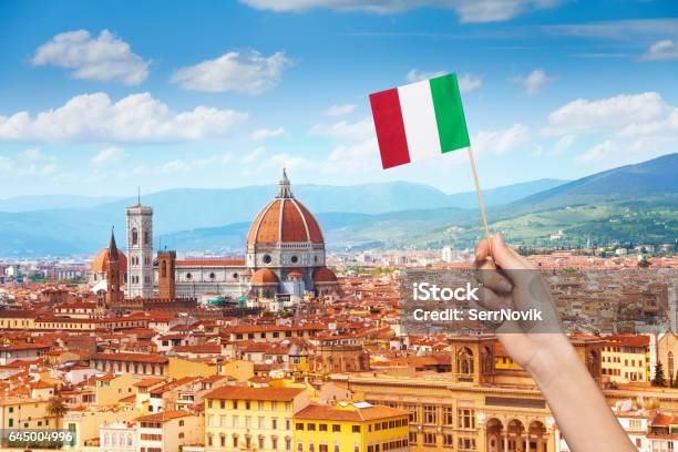 Hand With Italian Flag And Cityscape Of Florence Stock Photo - Download Image Now - Cityscape, Coat Of Arms, Flagpole