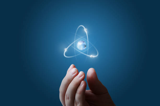 Atom structure model in a hand with nucleus and electrons, technological concept of nuclear power. Flat illustration on green background