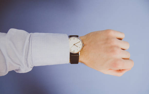 istock Man checking the time on a beautiful vintage wristwatch. 645015314