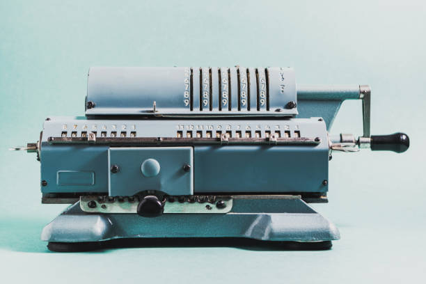 istock Old calculating machine on a green background. Accounting or business concept 645016470
