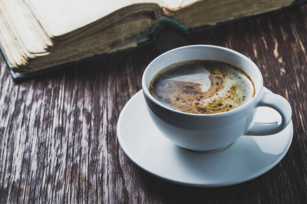 istock A Cup of coffee and old book. Breakfast concept 645016568