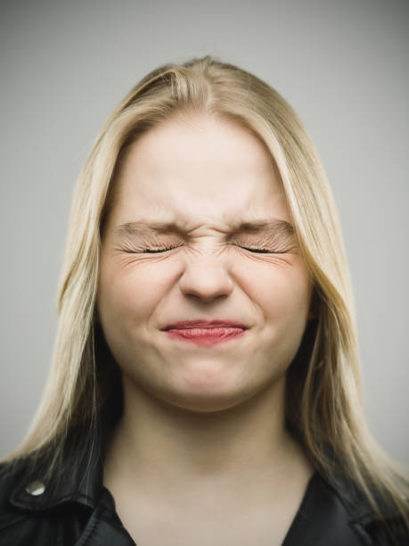 Young woman baring her teeth, angry expression