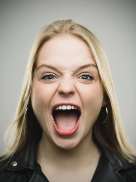 istock Excited woman screaming against gray background 645023010