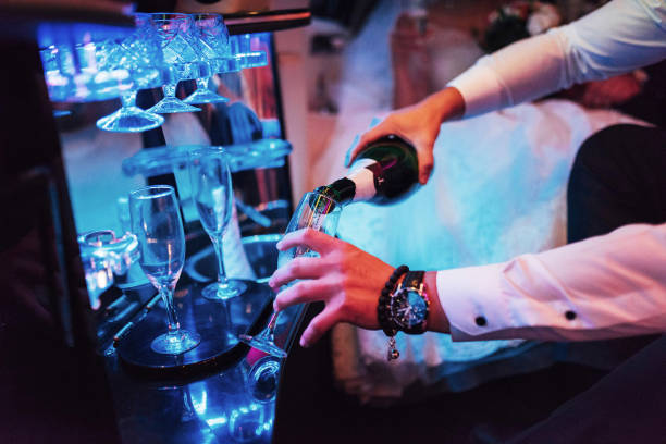 istock waiter pours champagne into glass 645023932