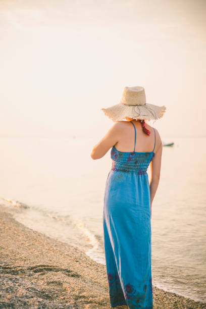 istock beautiful young female enjoying a day at the beach 645026332