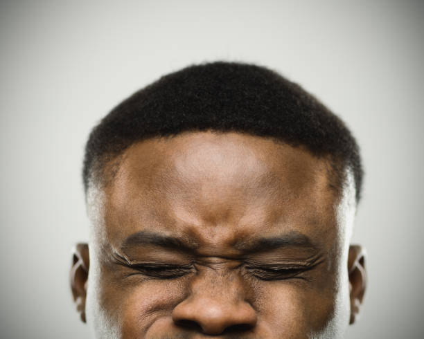 istock Angry man with eyes closed clenching eyes 645027816