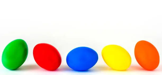 Five colorful Easter eggs against a white background