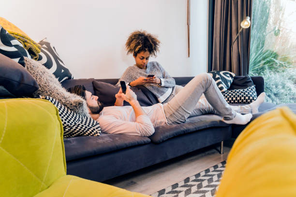 istock Beautiful young couple looking at smartphone 645033660