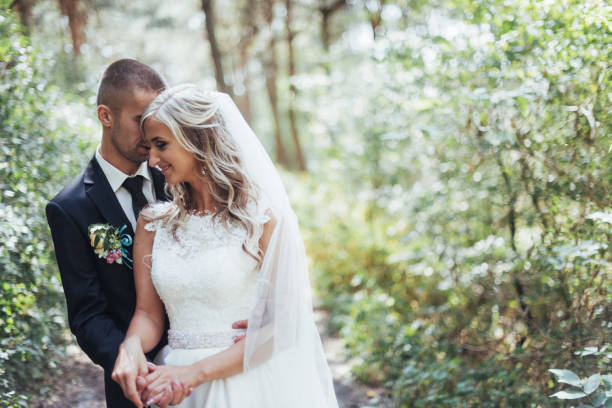 istock groom at a park on their wedding day 645049768