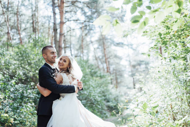 istock groom at a park on their wedding day 645050874