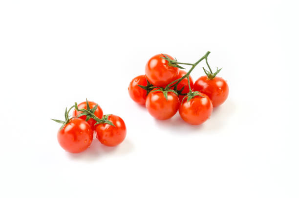 Cherry tomatoes Brunch of cherry tomatoes isolated on a white background cherry tomato stock pictures, royalty-free photos & images