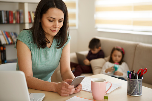 Multitasking mother working from home