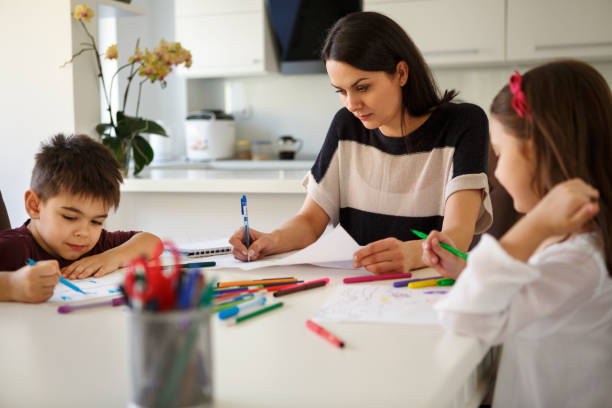 istock Single mother with children working from home 645060132