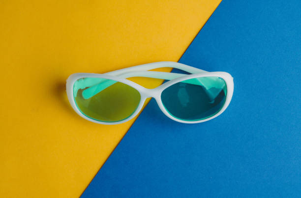 istock White sunglasses on a blue yellow background. Rest concepts 645067288
