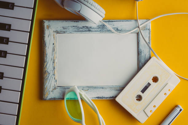 istock Audio cassette and headphones on a yellow background. Mock up 645067344