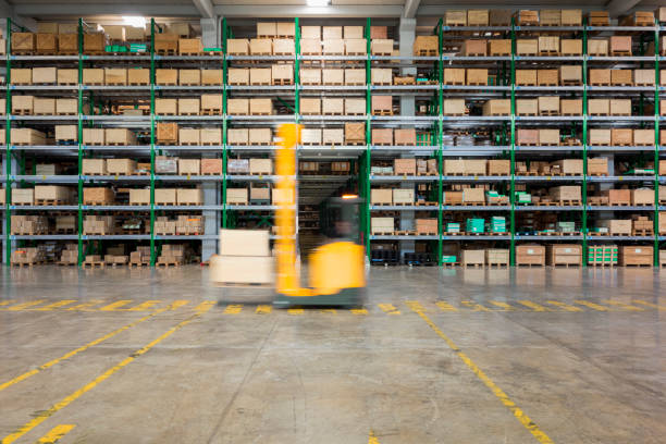 istock Forklift carrying cardboard box in warehouse 645067990