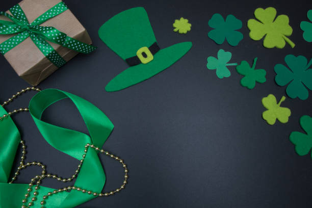 istock Irish decorations for St. Patricks Day clover leaves on blackboard 645068442