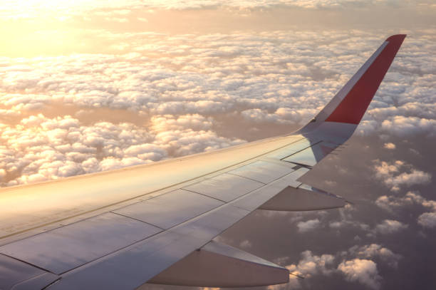 istock Sunset time and flare with airplane wing from the inside. 645069268