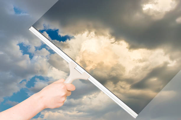 istock Cleaning window with squeegee to clean the sky 645072400