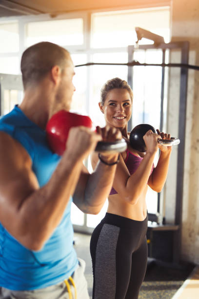 istock Two young athlete people doing kettlebell exercises at gym. 645081244