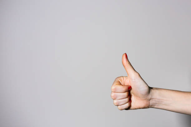 istock Woman's thumb up sign on a white background 645088668