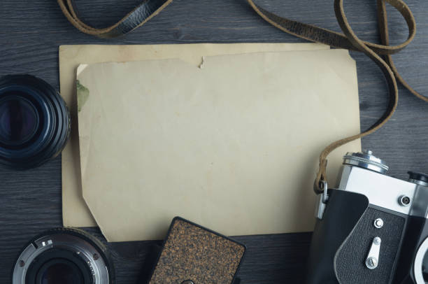 istock Old camera and lenses on dark wooden background 645092618