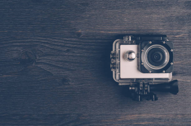 istock Action camera on a dark wooden background. Travel concept 645092806