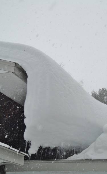 istock Snow overload on house roof 645093126