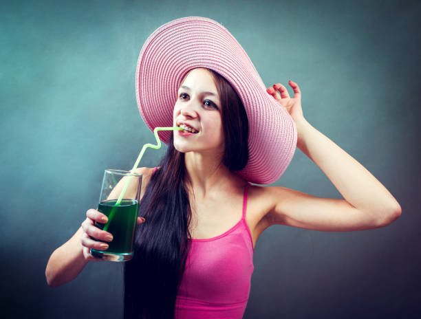 istock Stylish senior woman drinking cocktail in studio 645095906