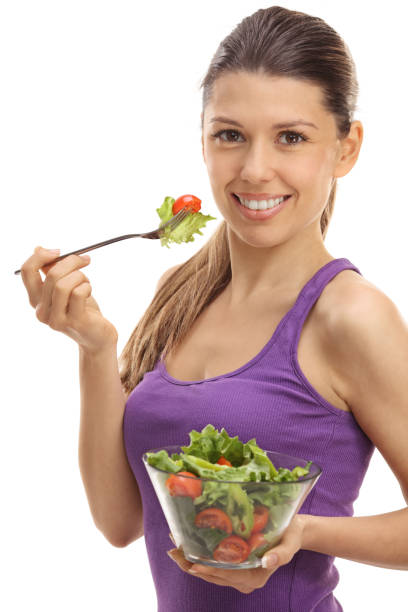 istock Joyful young woman eating a salad 645096458