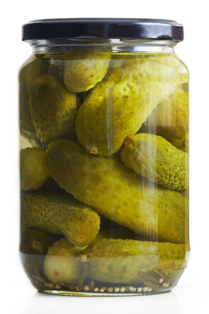 Preserved pickled cucumbers Jar of pickled cucumbers isolated on white background pickled stock pictures, royalty-free photos & images