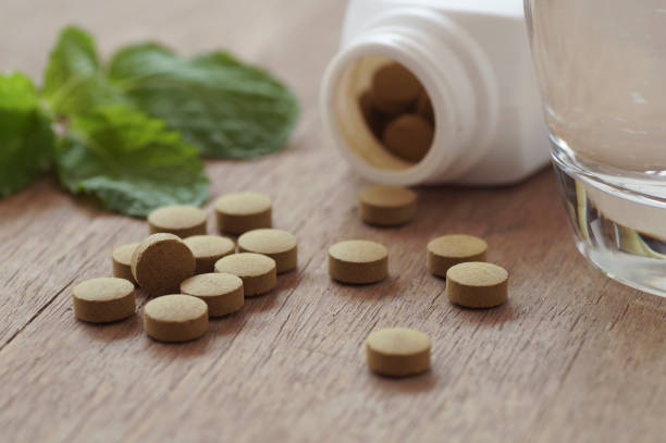 istock herb medicine in pill on wood table 645099210