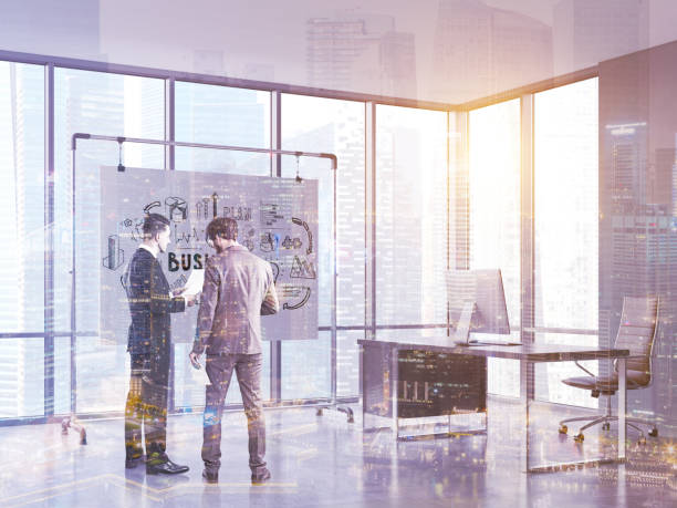 istock Businessmen looking at papers in office, toned 645100046