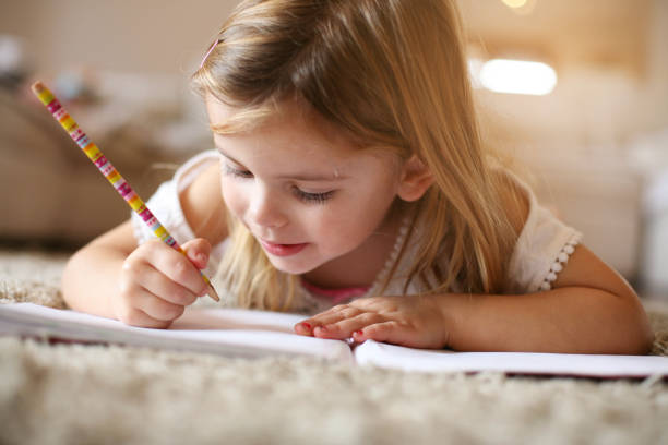istock Little  girl writing  at home. 645104634